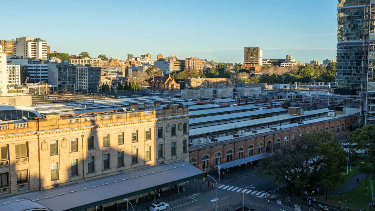 Sydney Central Station's sandstone building and platforms from above