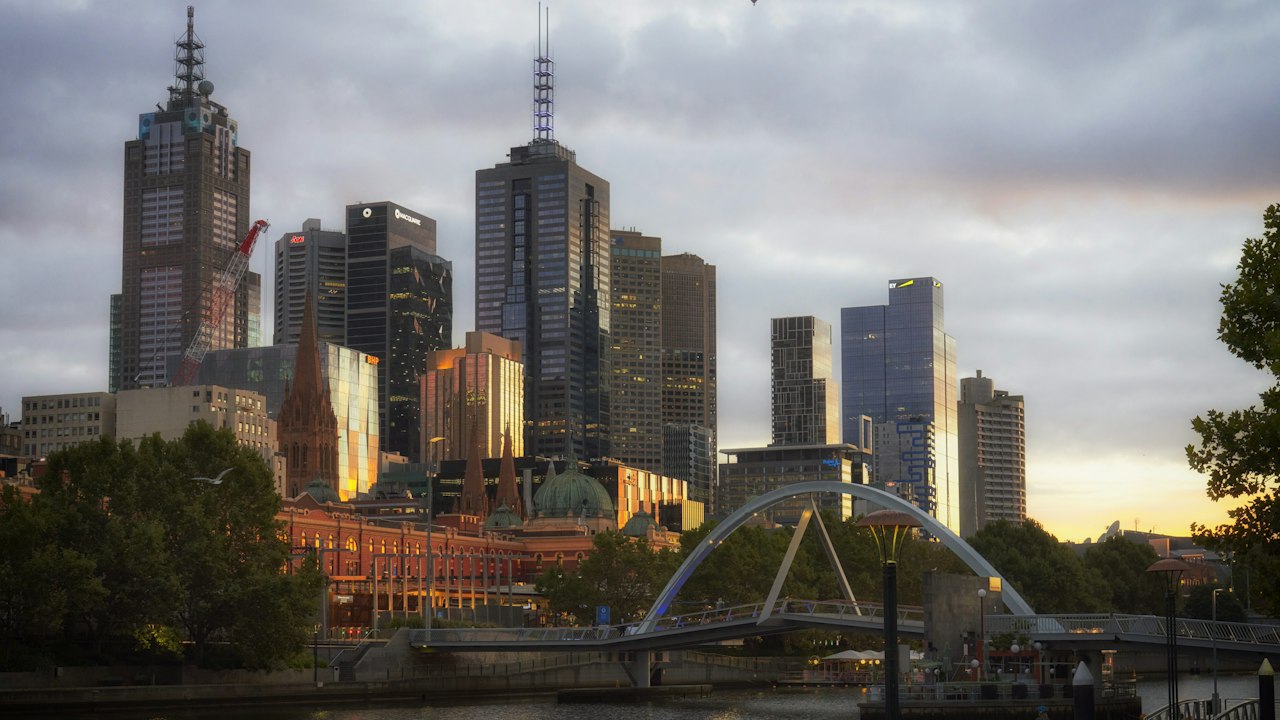 Flinders Street Station, St Paul's Cathedral and the Melbourne skyline beside the Yarra River
