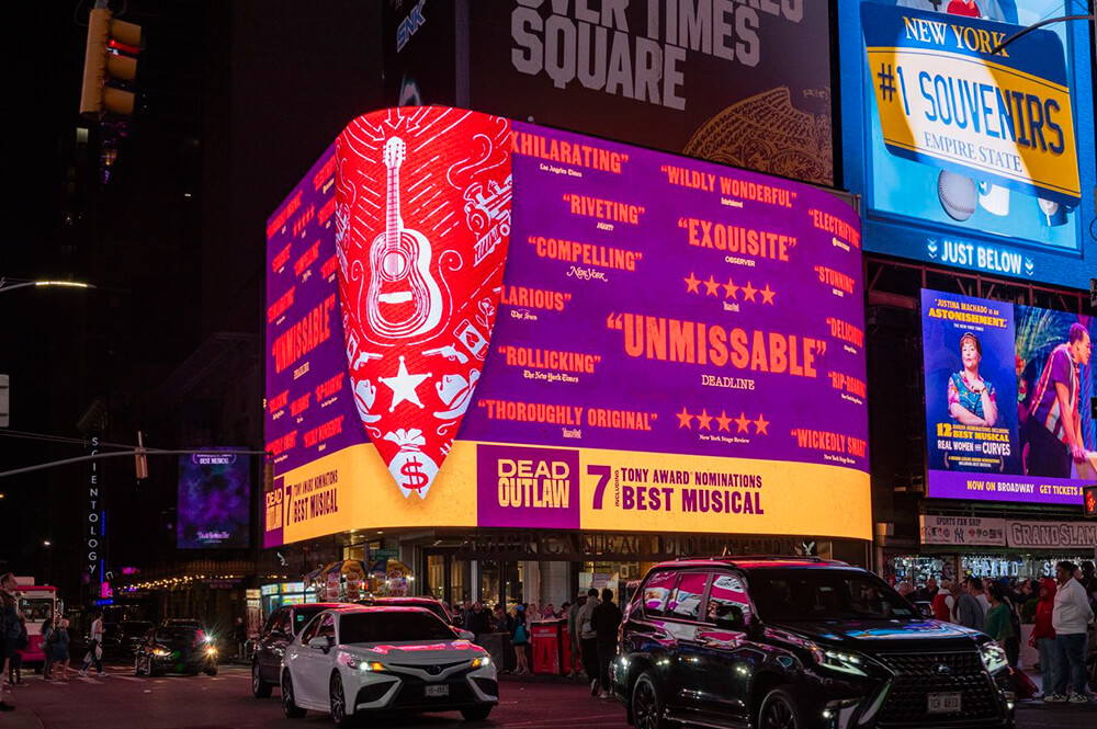 A large digital screen in Times Square atop the American Eagle store. The screen wraps around a corner.