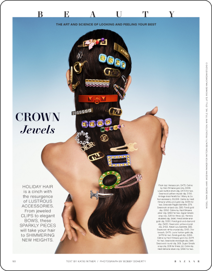 Back view of woman with long dark hair adorned with various jeweled hair clips and accessories.
