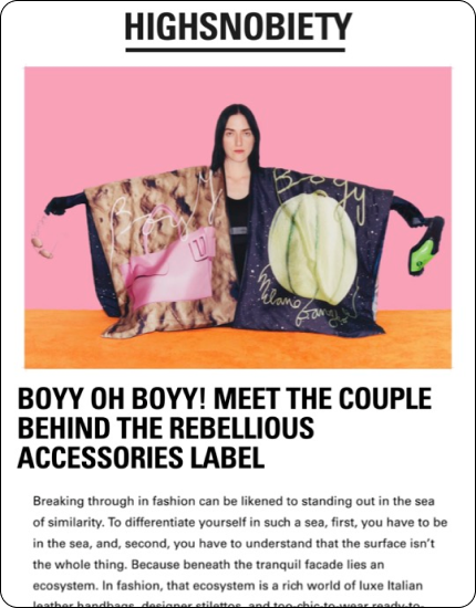 Model wearing oversized, colorful Boyy accessories cape with text about the rebellious accessories label.