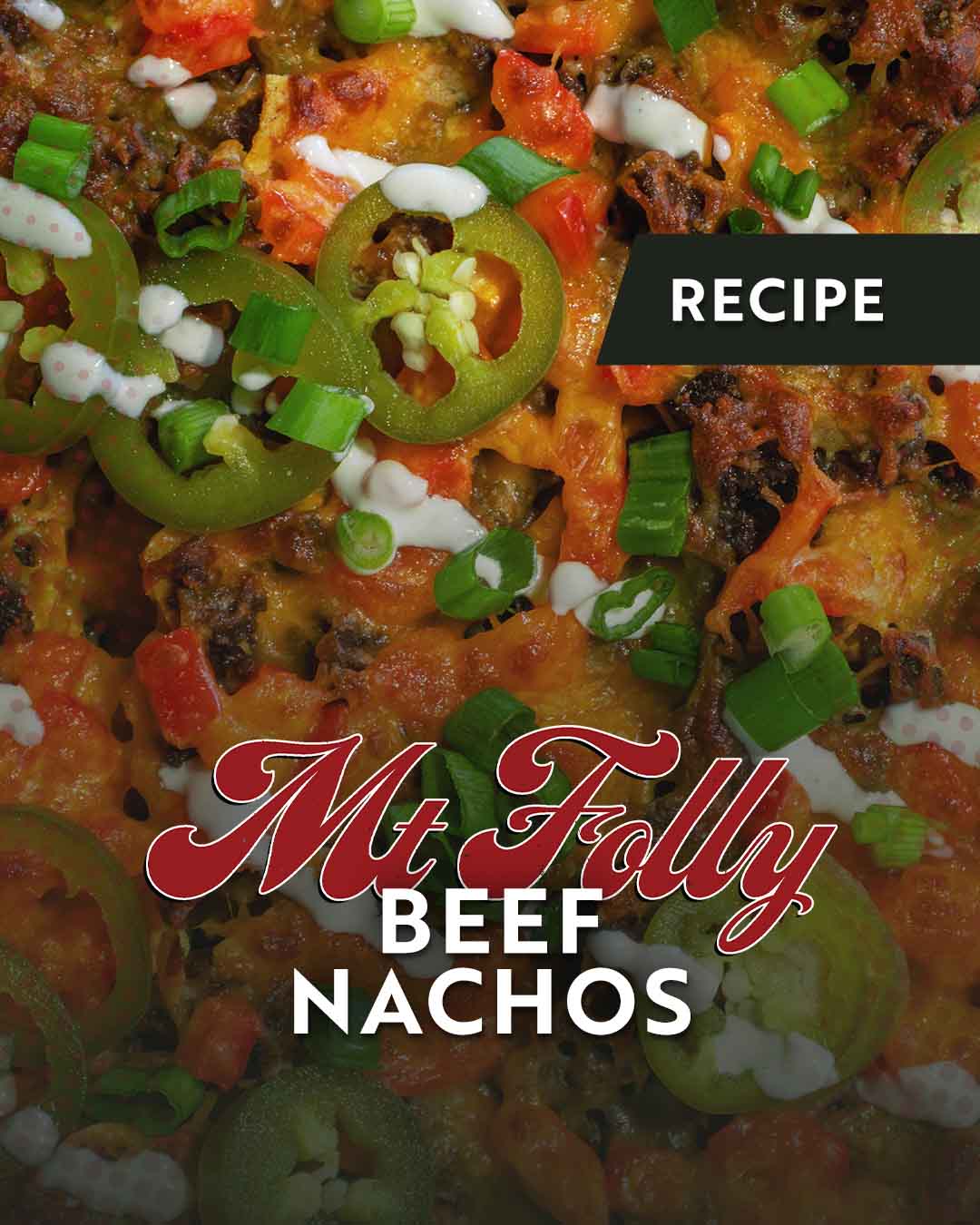 Close-up of loaded Mt. Folly Beef Nachos topped with melted sharp cheddar, fresh green onions, and house-pickled jalapeños, highlighting local Kentucky pasture-raised beef.