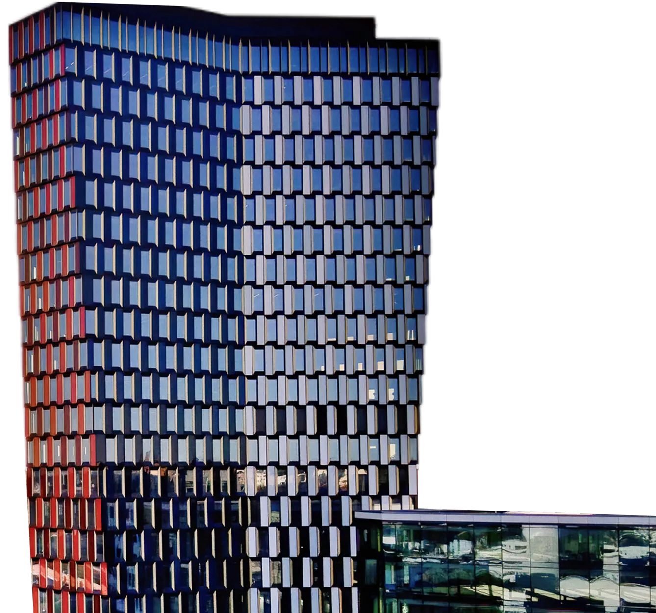 Modern RiseRank  office building with a grid of reflective rectangular windows and an adjacent lower glass structure.