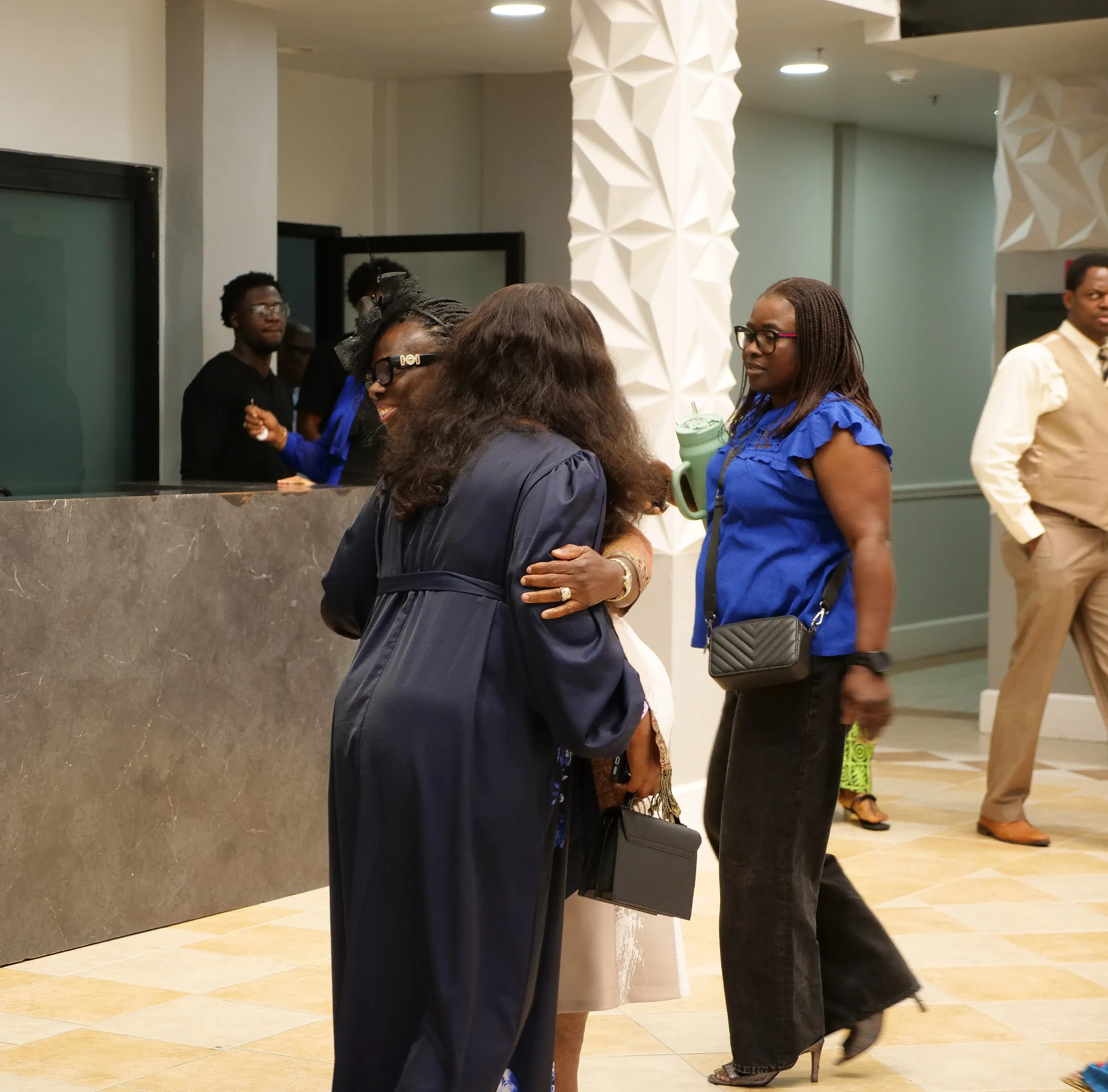 Members greeting each other with a hug