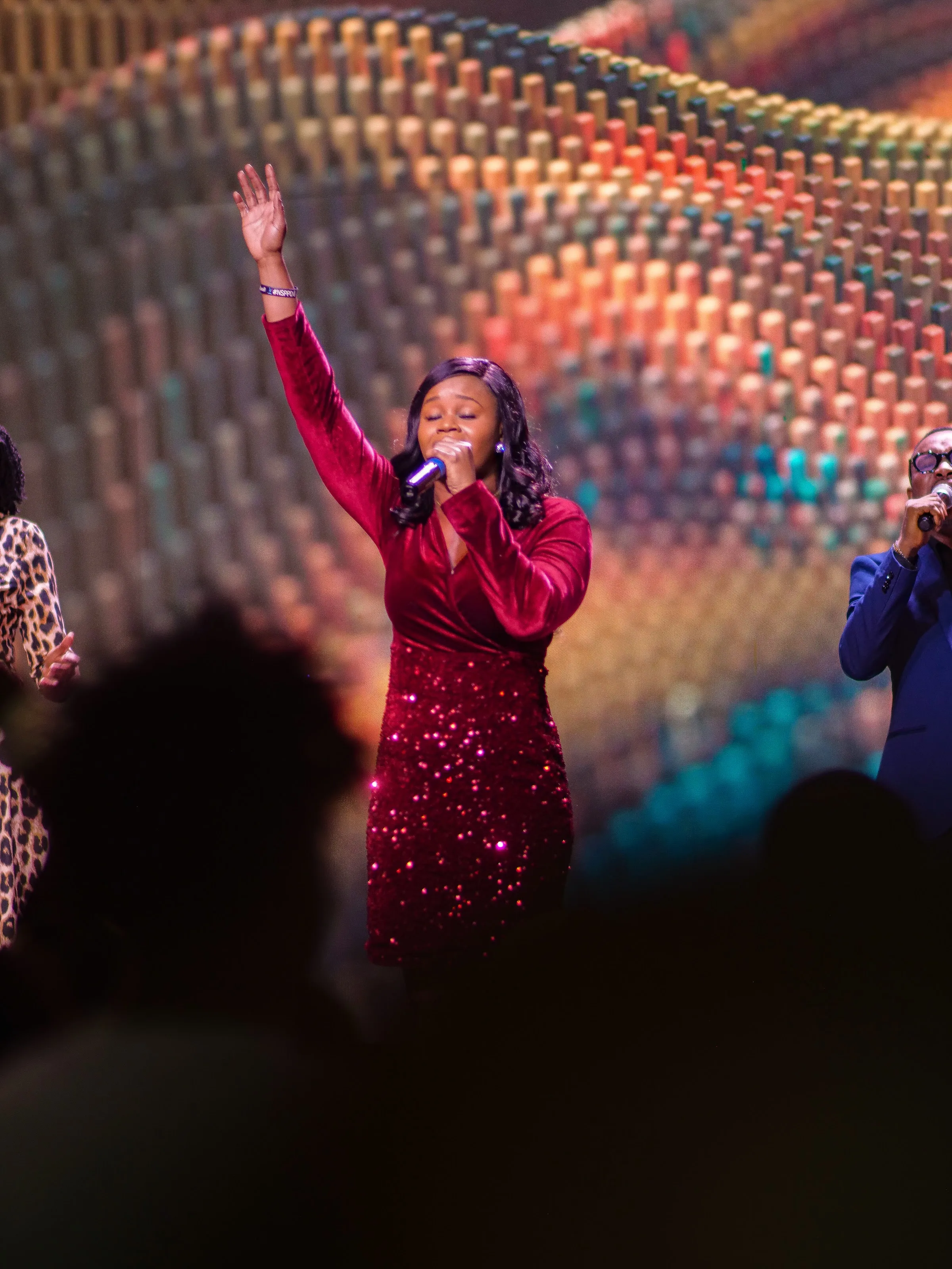 A worship leader singing at Living Word Chapel