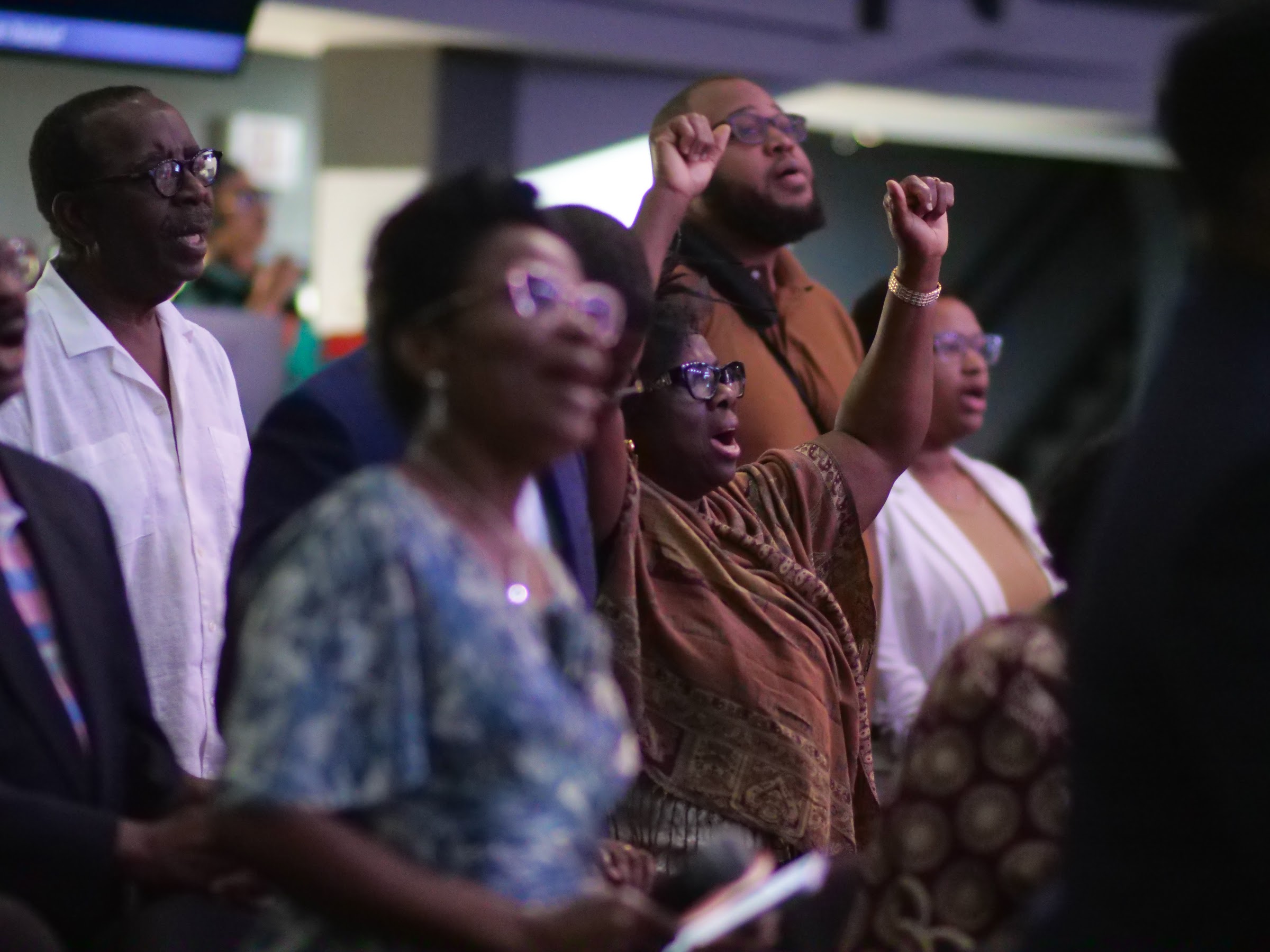 Members lifting their hands in worship