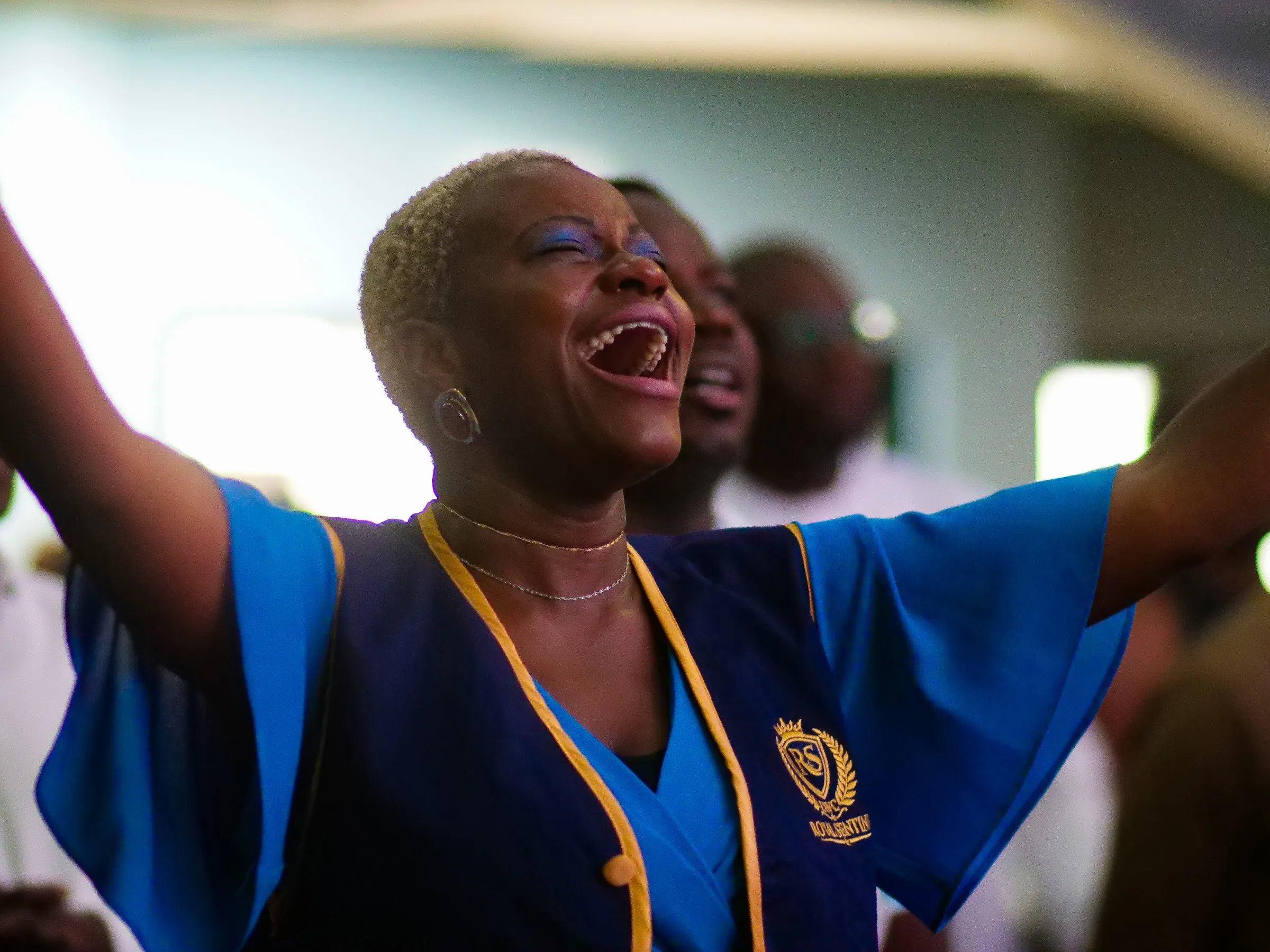 A woman worshipping with joy at Living Word Chapel