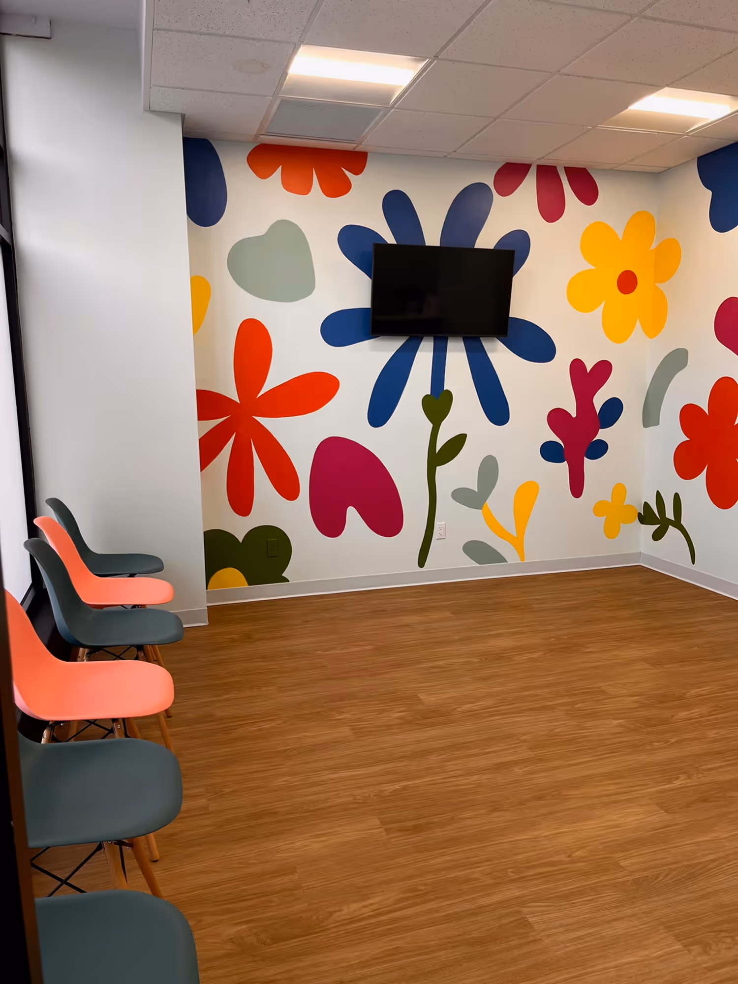 A room with a flower painted on the wall.