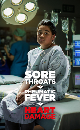 A young boy sitting in a hospital operating theatre