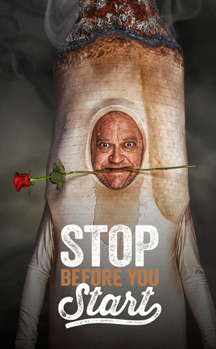 A person dressed as a cigarette with a rose held in their teeth