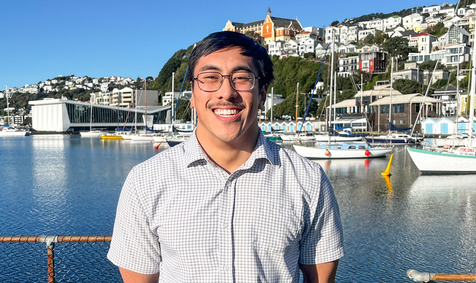 Kokoro Frost standing in front of boats in the Wellington City harbour.
