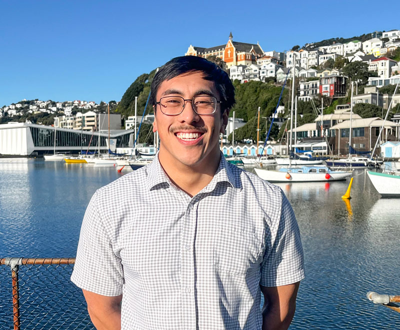 Kokoro Frost standing in front of boats in the Wellington City harbour.