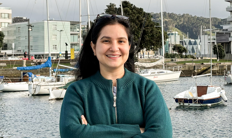 Priyanka Bhanot standing in front of the marina at Wellington Harbour.