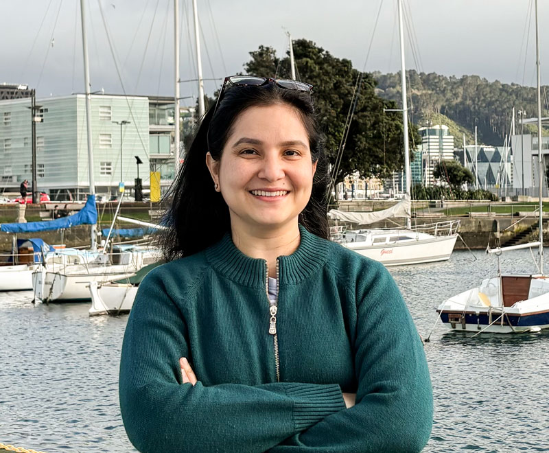 Priyanka Bhanot standing in front of the marina at Wellington Harbour.