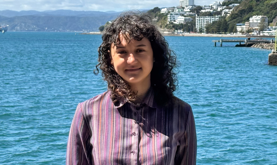 Maia Moana standing in front of Wellington Harbour.