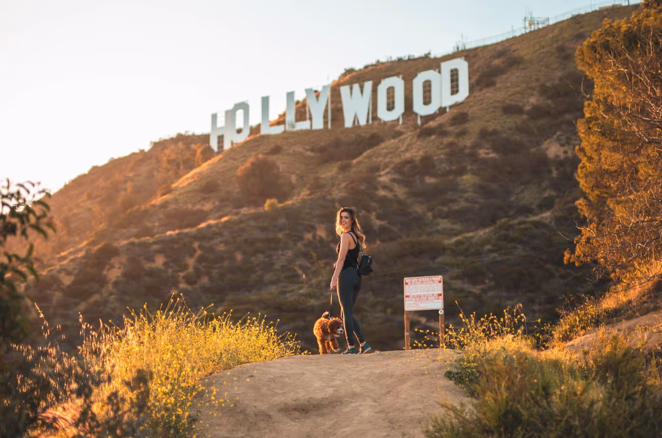 Woman with a dog hiking the Hollywood Sign