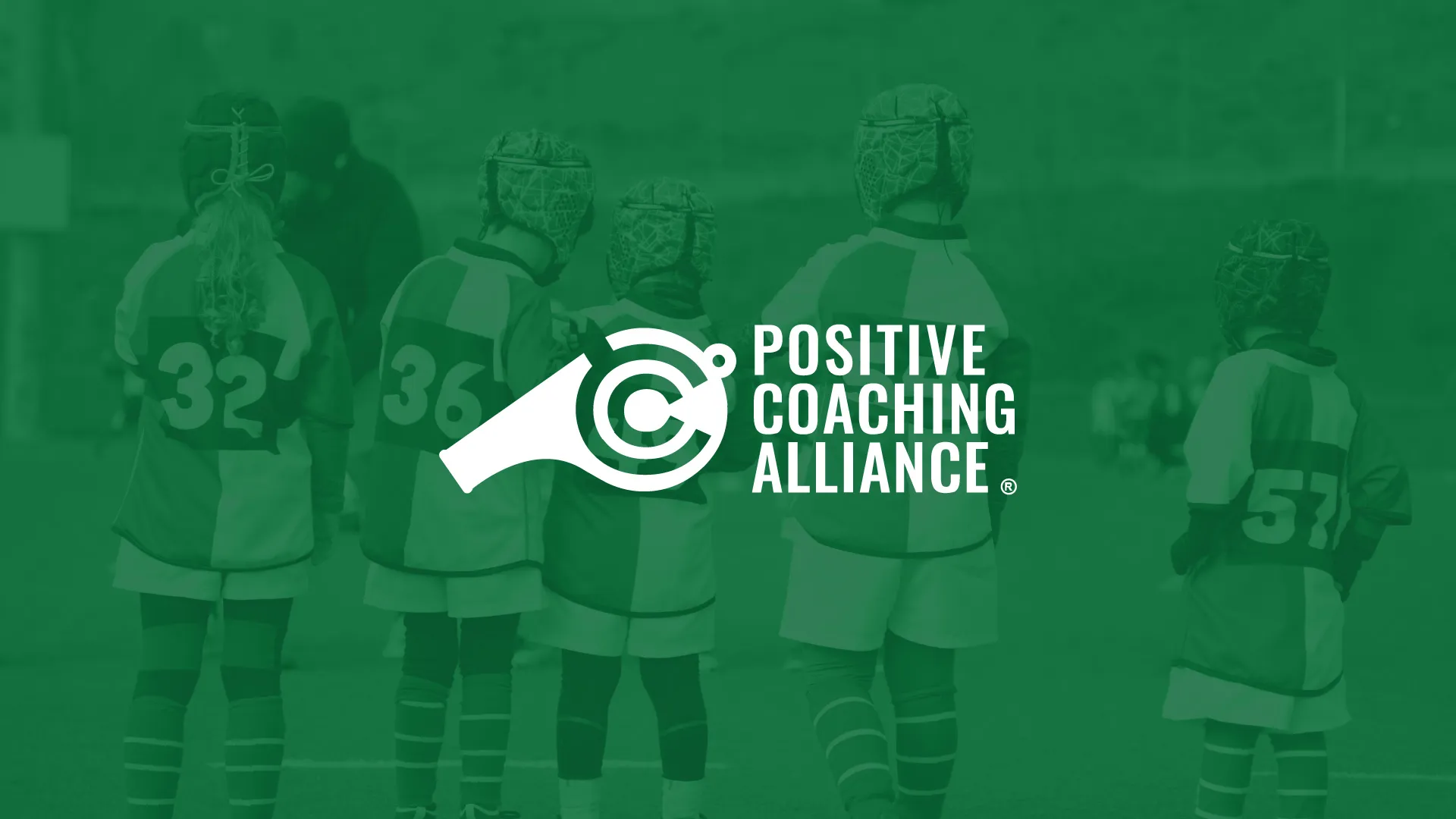 Young rugby players standing on a field wearing helmets and numbered jerseys with Positive Coaching Alliance logo overlay.