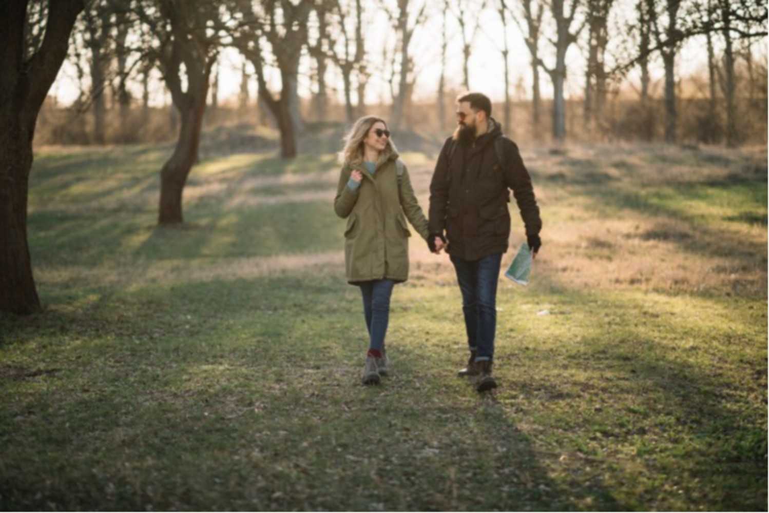 Cheerful farmers market seller putting fresh produce in box