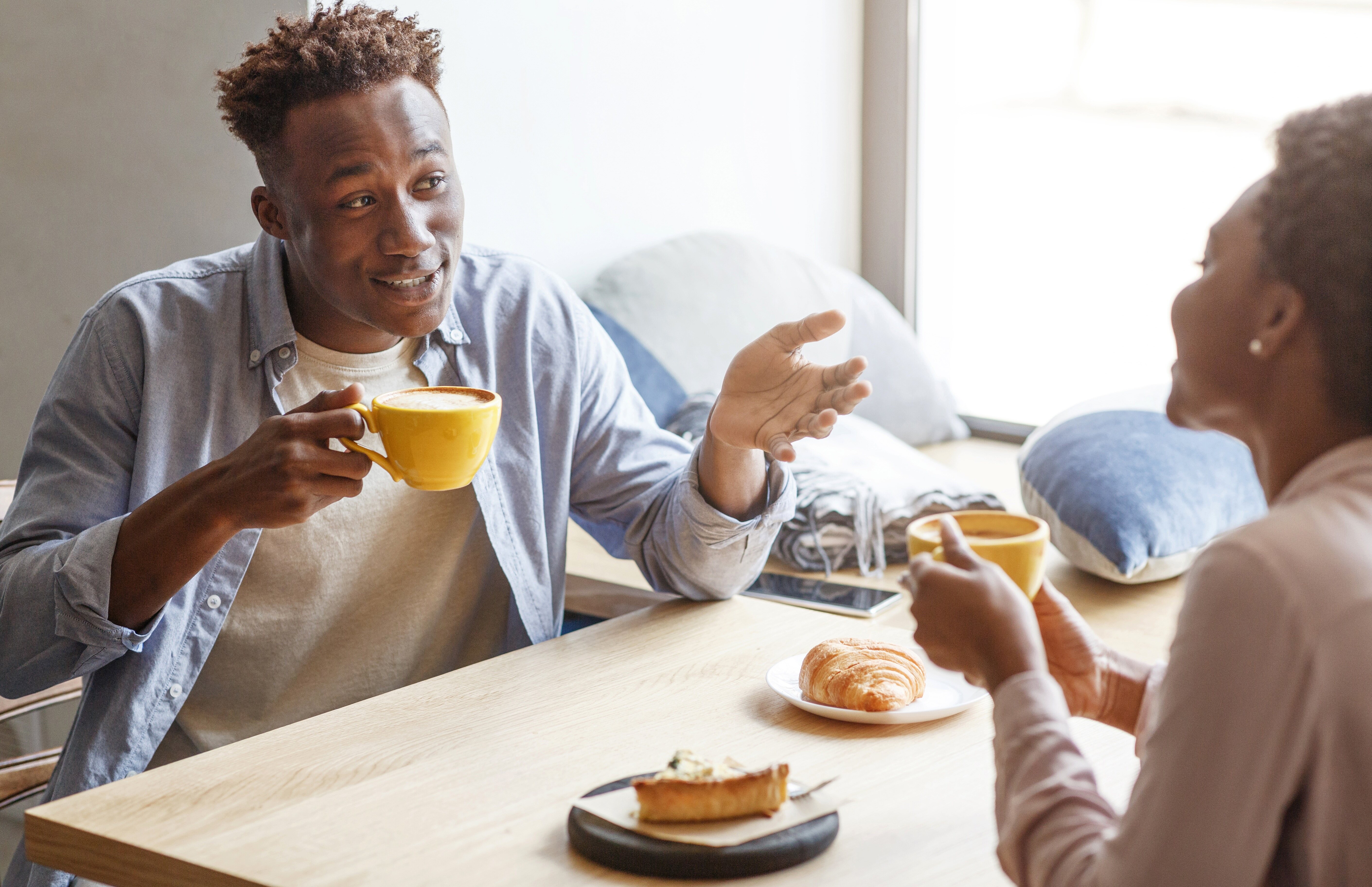Two people sharing coffee and conversation on a date, illustrating the value of staying open to meaningful connections.