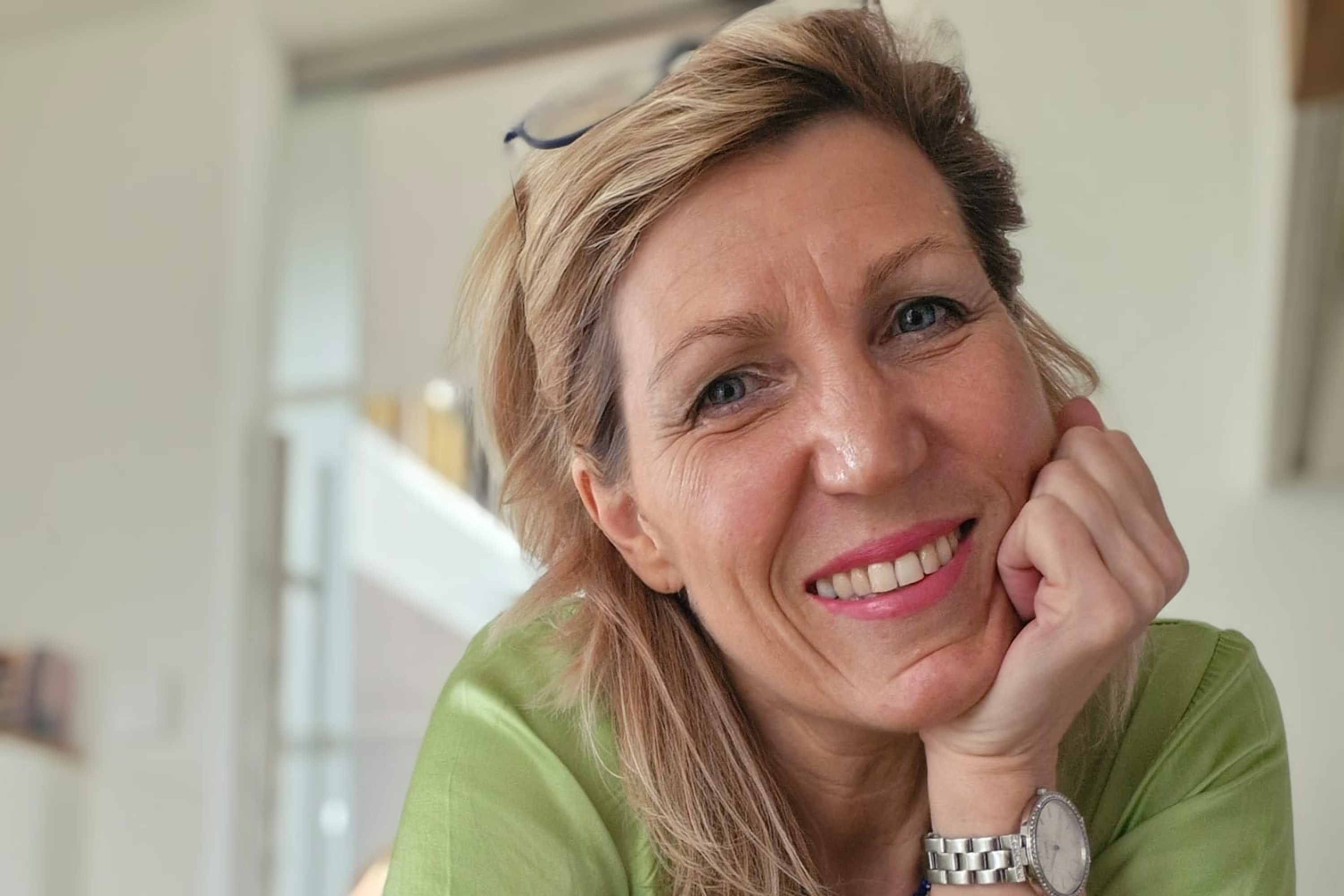 Nicole Racky. A woman with blond hair and a big smile. 