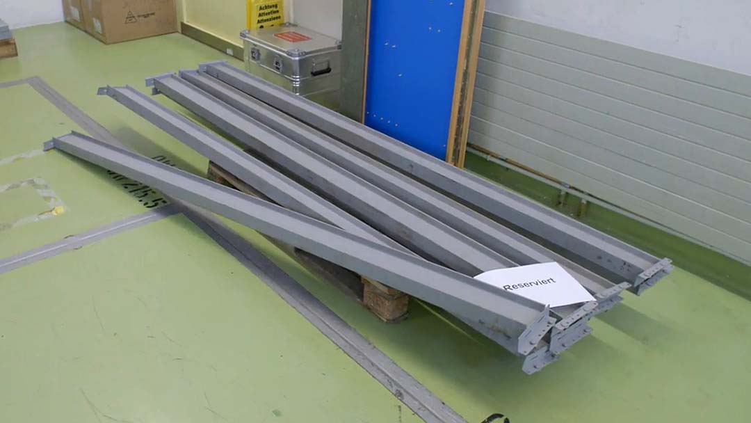 Foto von Metallträgern, die auf einer Holzpalette liegen