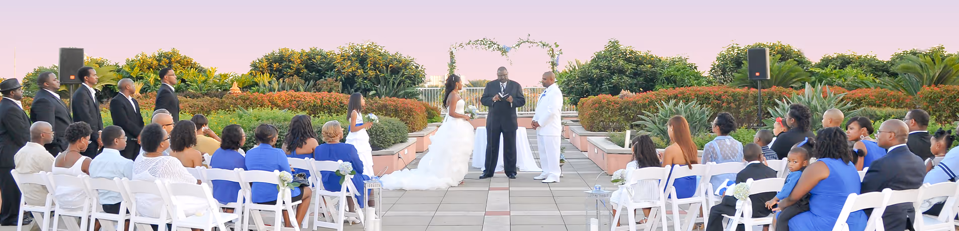 Two individuals, a woman and a man sitting in the executive conference room located on the 9th floor of the Moody Gardens hotel for a meeting. The woman is showing the man an item on her laptop display screen as he looks up from behind his own laptop. 