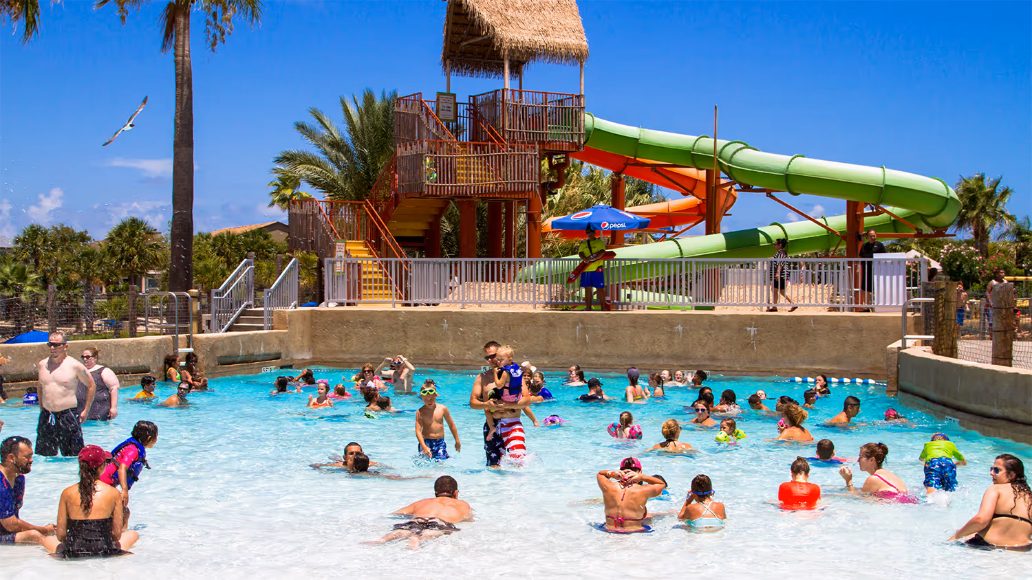 Kids walking into the water at Palm Beach Moody Gardens