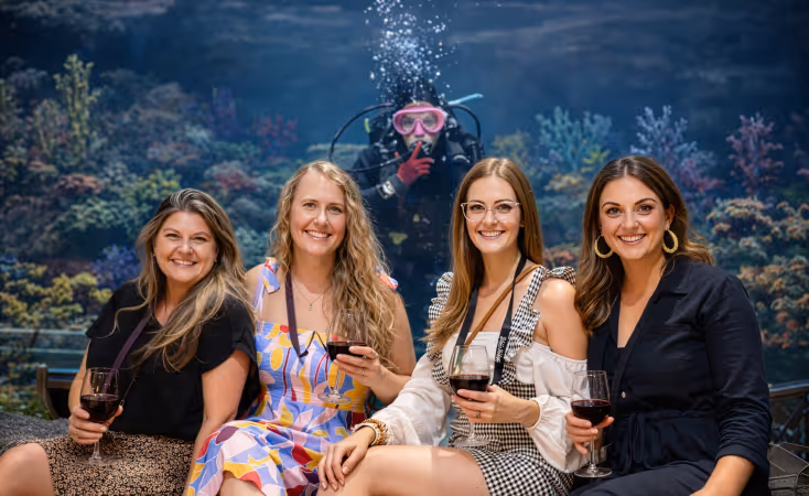 Galveston Island Wine Festival header showing the tunnel inside the Aquarium Pyramid while a large stingray swims above. 