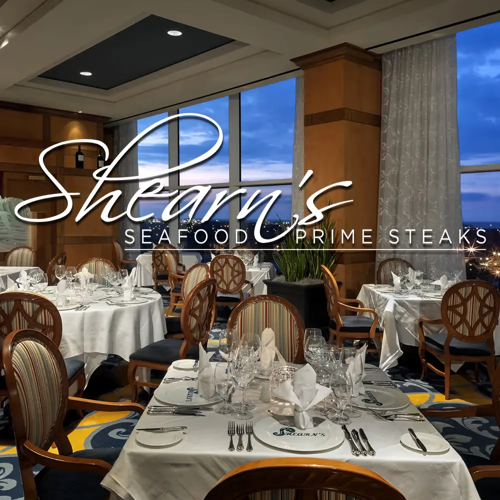 Guests dining in Shearn’s Lounge at dusk as the Pyramids light up