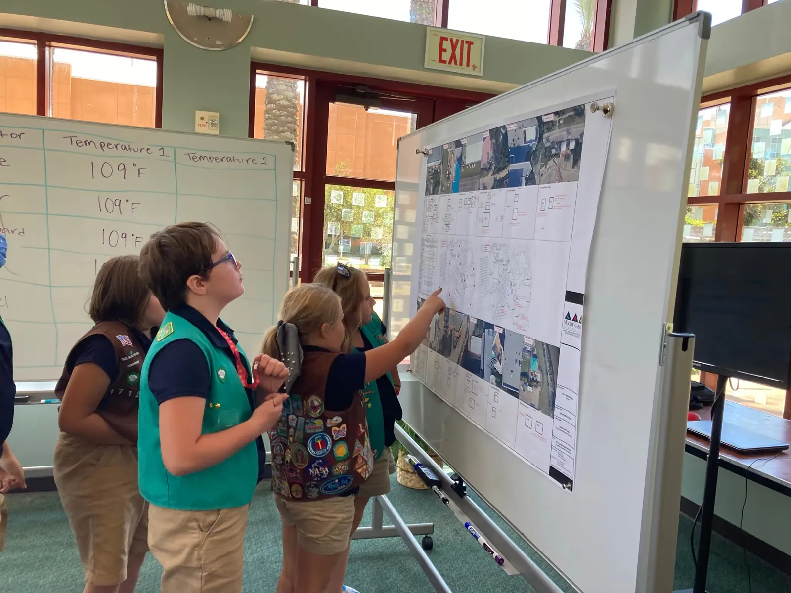 Girl Scouts point to a planning board during a Moody Gardens badge workshop
