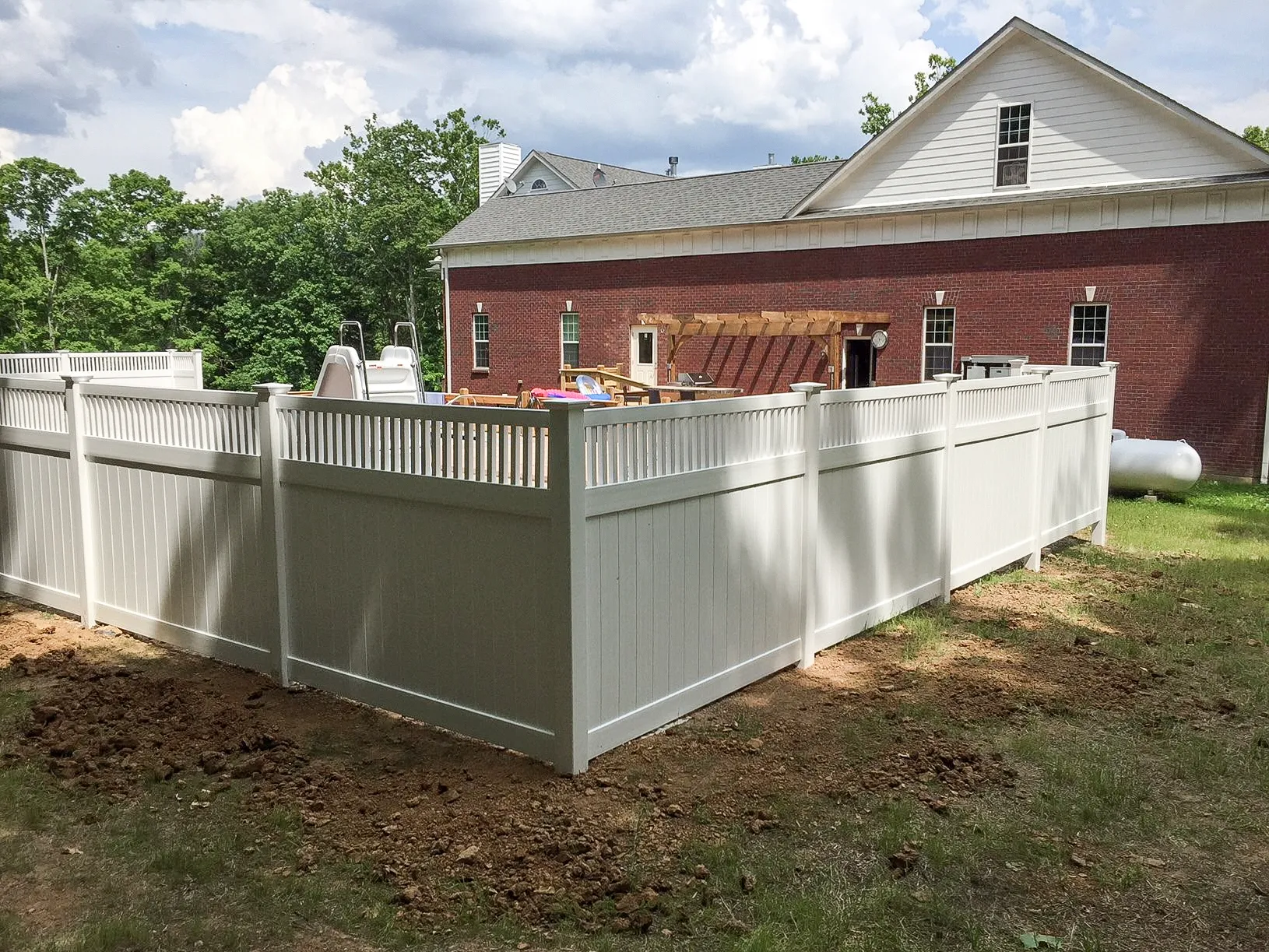 White vinyl privacy and pool enclosure fence installed in Versailles, Kentucky