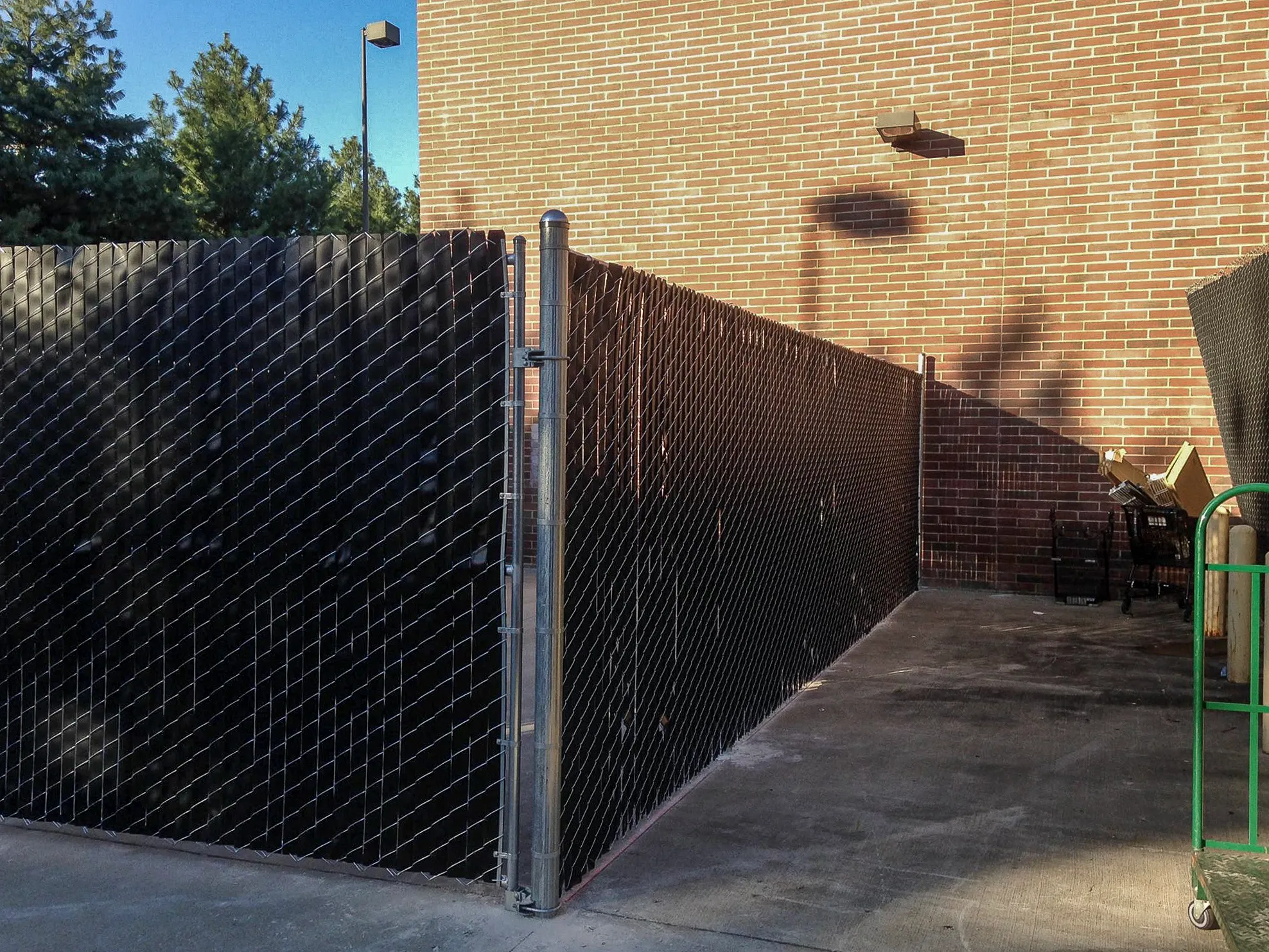 Black vinyl-slatted chain-link privacy fence installed at Kroger on Euclid Avenue in Lexington, Kentucky
