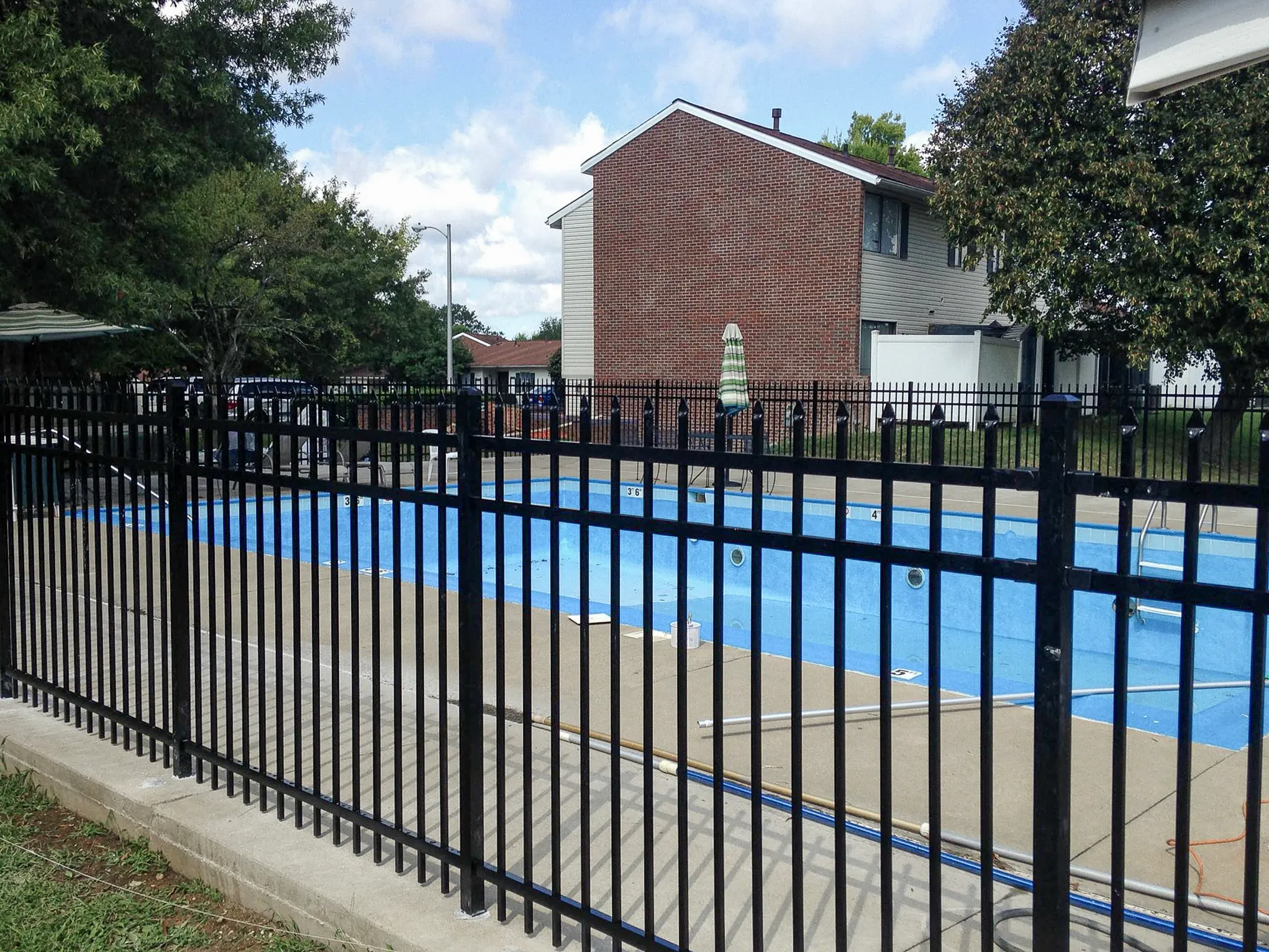 Black Maine-style aluminum pool safety fence installed at Villa Townhomes in Lexington, Kentucky