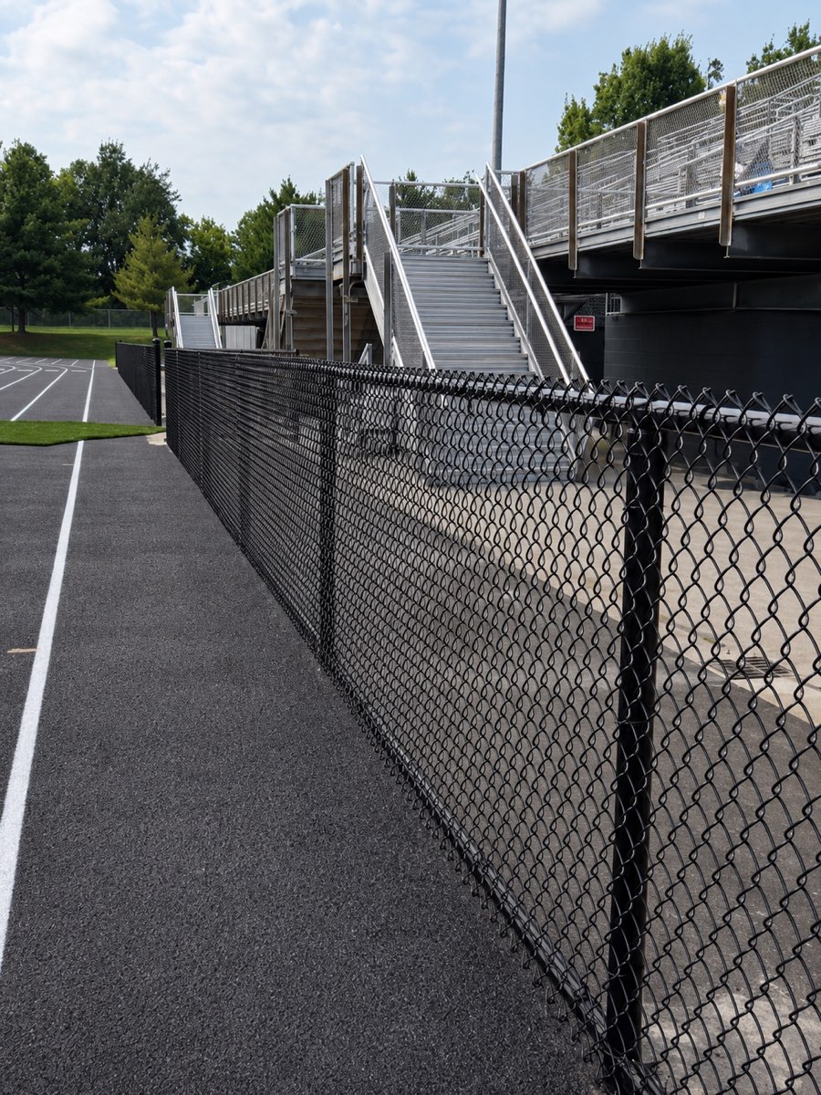 Black chain-link stadium fence surrounding the athletic facilities at Dunbar High School in Lexington