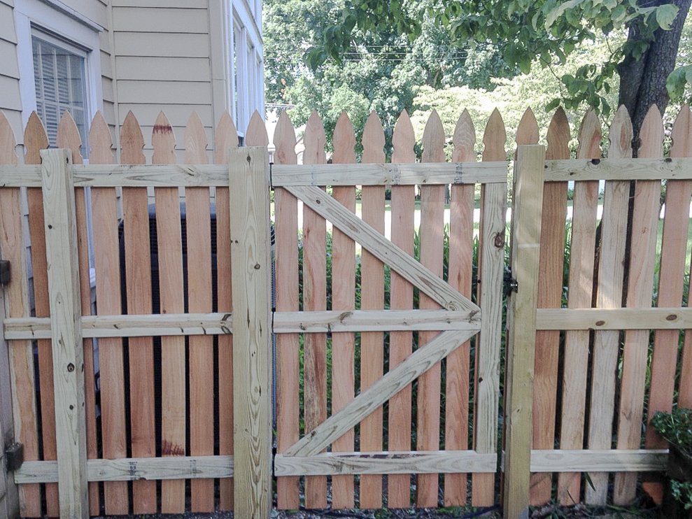 Inside face of a cedar pedestrian gate showing diagonal wood bracing in Midway.