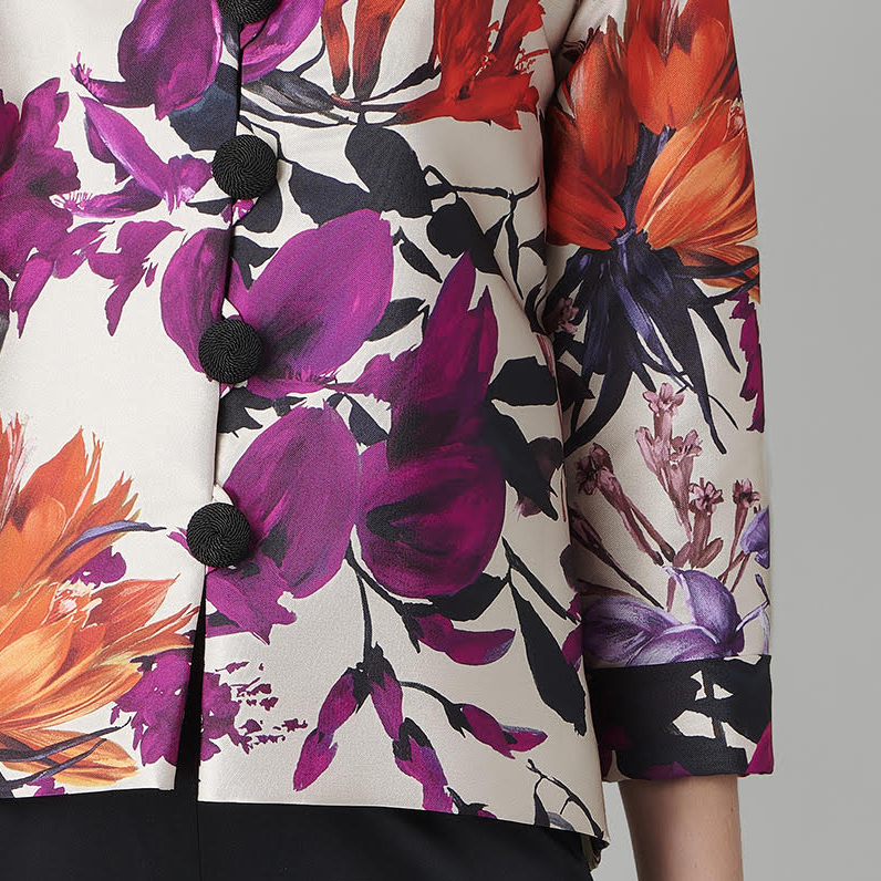 purple and orange floral pattern on a white jacket.