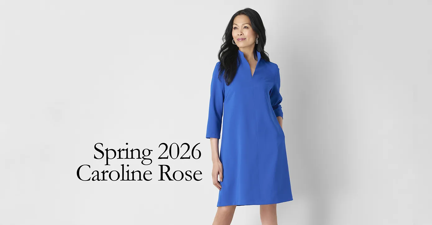 Woman in a royal blue knee-length dress with three-quarter sleeves, standing against a light gray background with text 'Spring 2026 Caroline Rose' to the left.