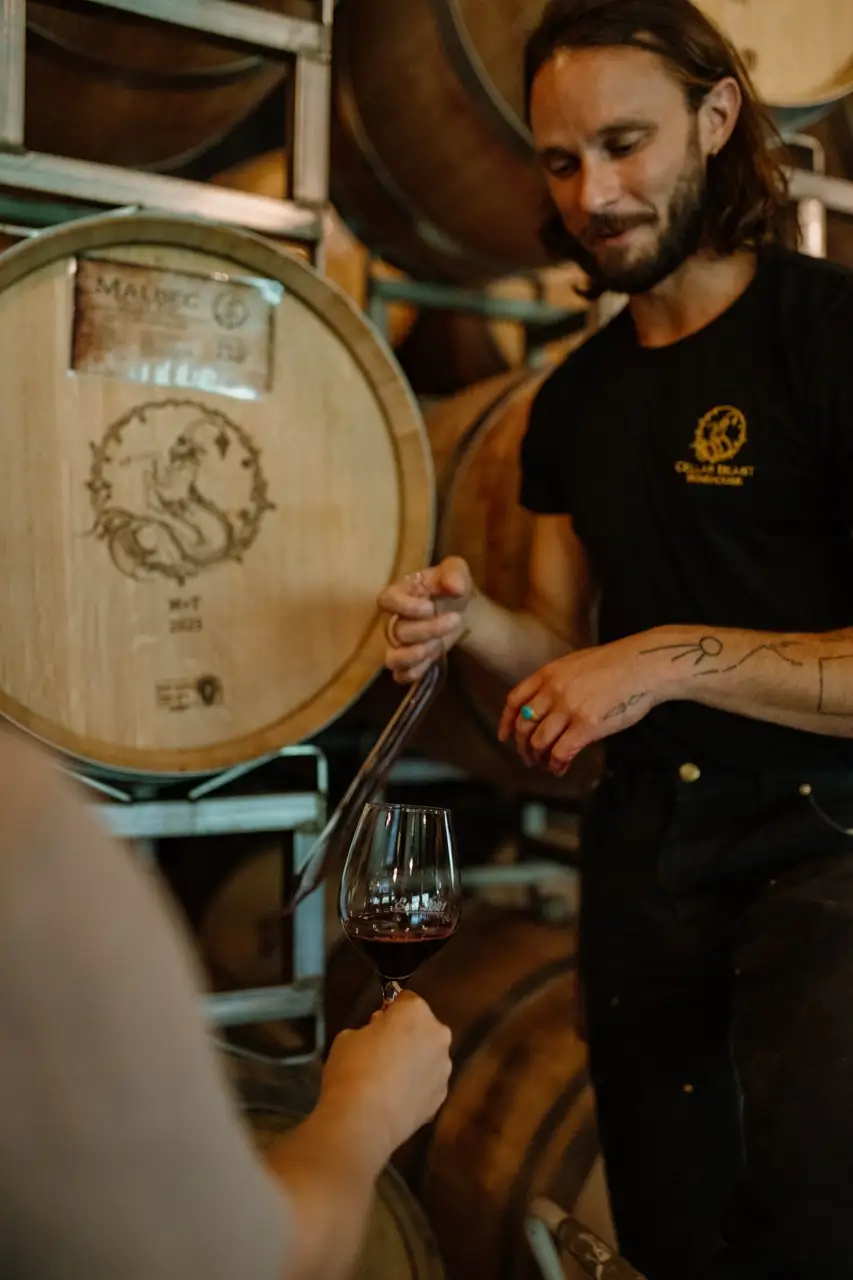 Aaron Gratch sampling 2023 Malbec from a barrel at Candy Mountain Vineyard – premium Washington wine by Cellar Beast Winehouse