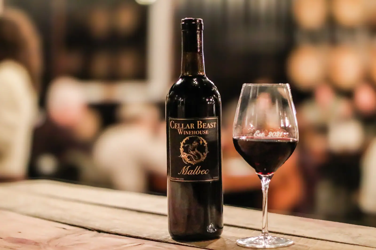 Cellar Beast Yakima 2022 Malbec grape wine bottle and glass on wooden table