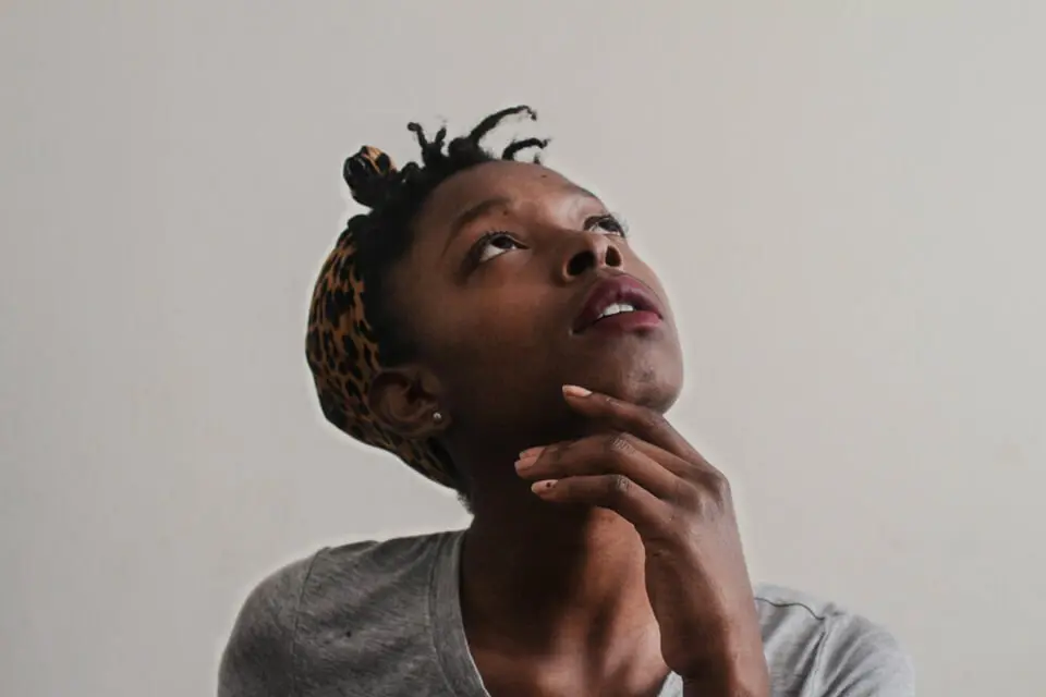Woman looking up, lost in thought