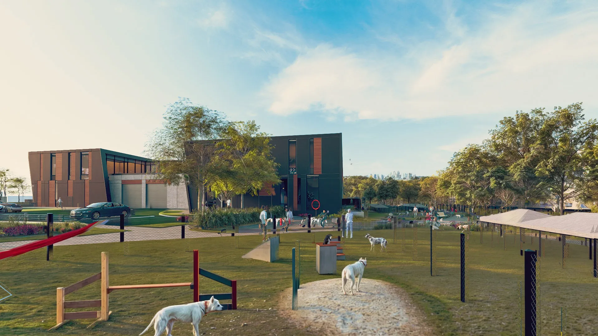 Park with dogs playing on grassy area featuring agility equipment, people walking, and modern buildings in the background.