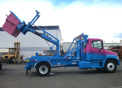 Western Cascade Container Stellar Container Carrier ECCR shown subframed for small Hooklift on Stellar Hooklift with custom features and Hedstrom Poly Front Load container in custom colors