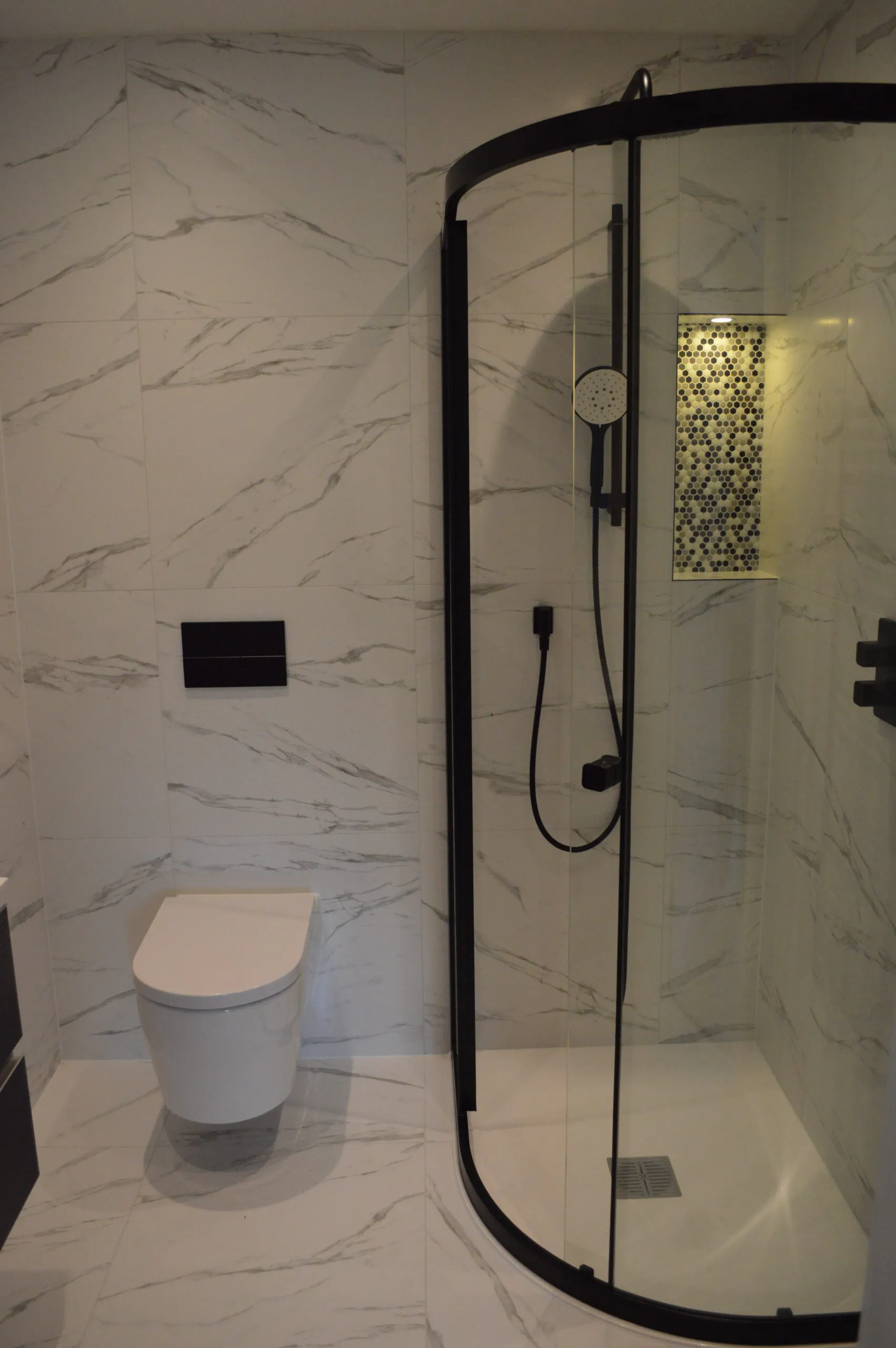 a bathroom with a toilet and a shower