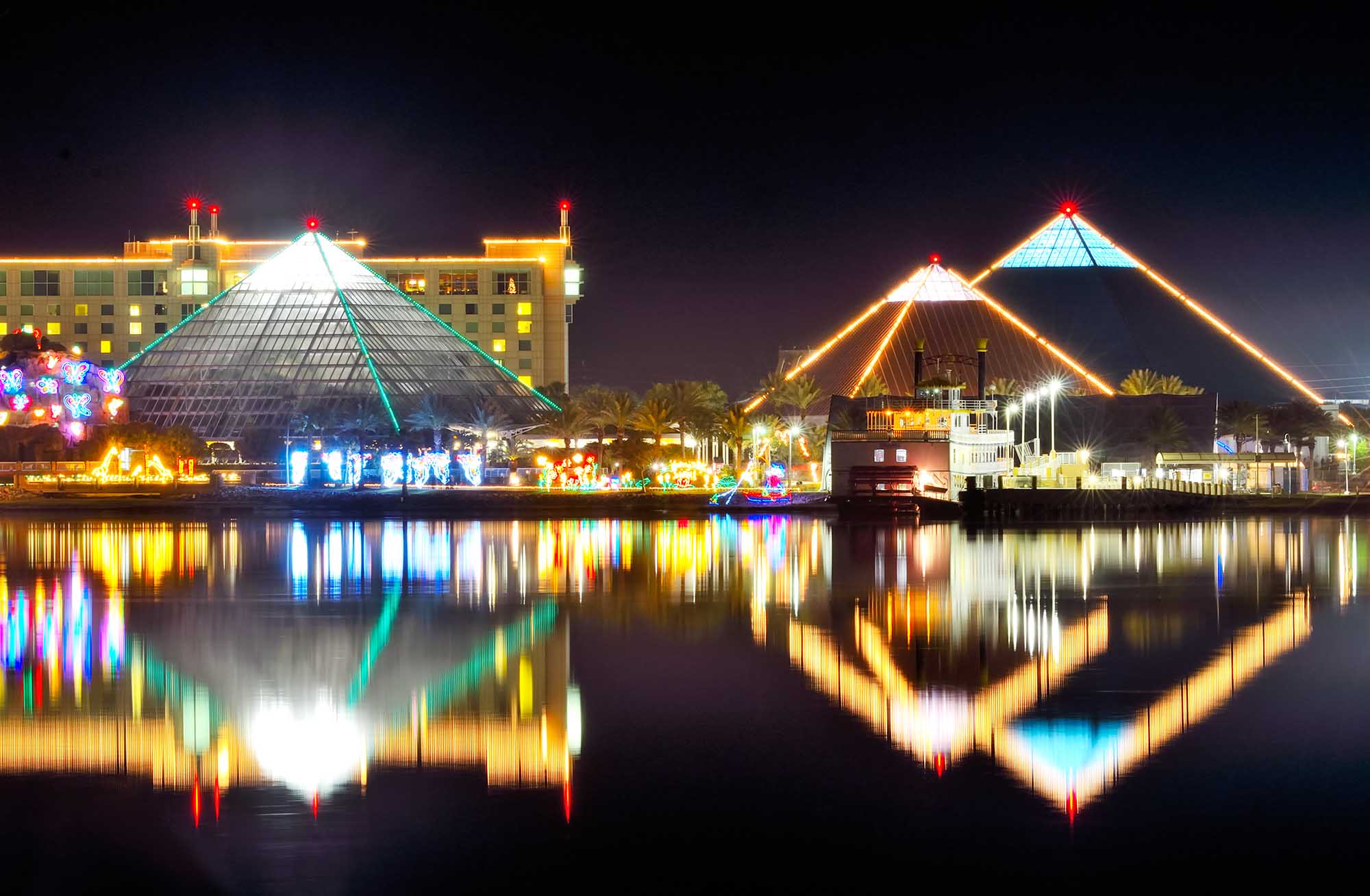 Moody Gardens logo on a pink to orange gradient, Galveston, Texas