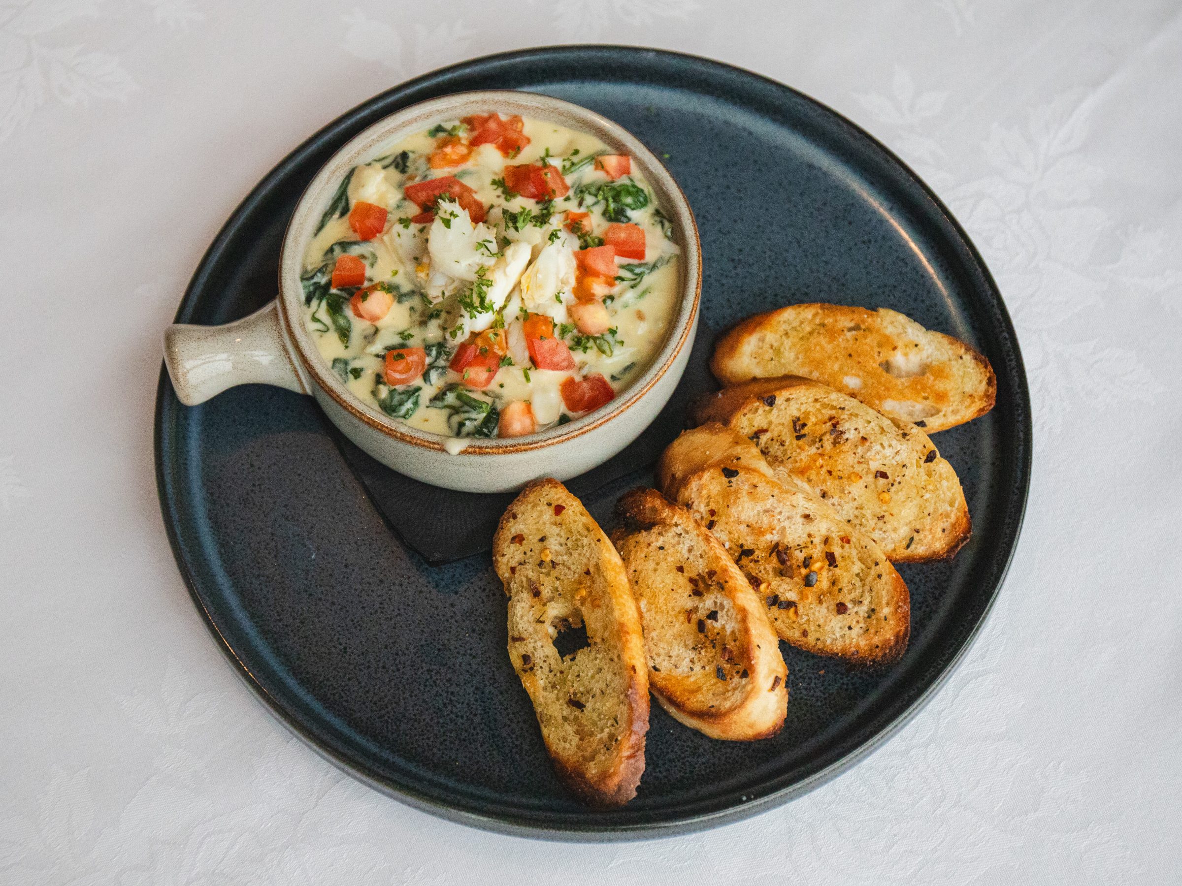 A crock of seafood dip with toasted bread at Shearn's