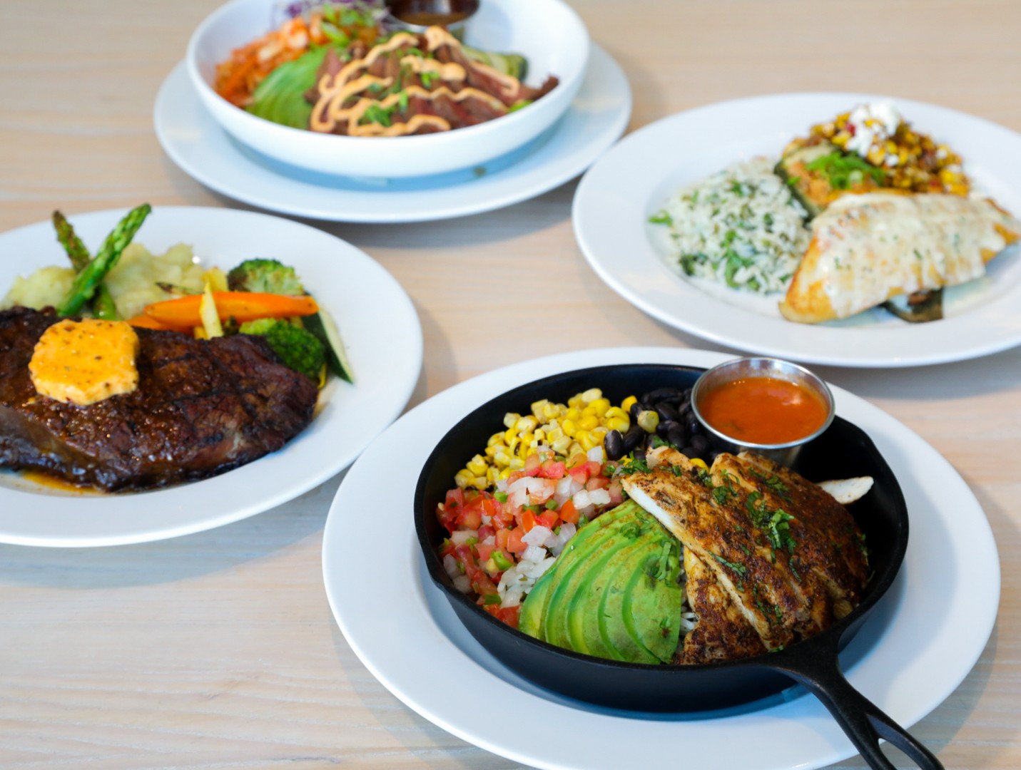 Steak, a Southwest skillet with avocado, and fish entrees at Café in the Park