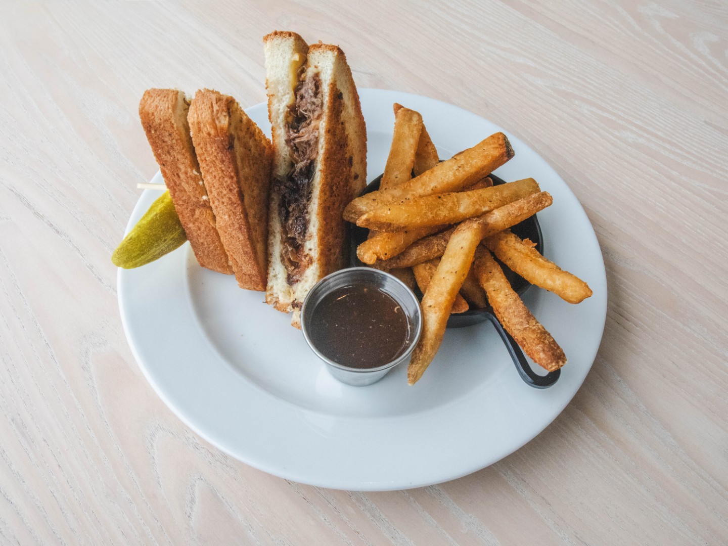 Patty melt with fries and a pickle at Café in the Park