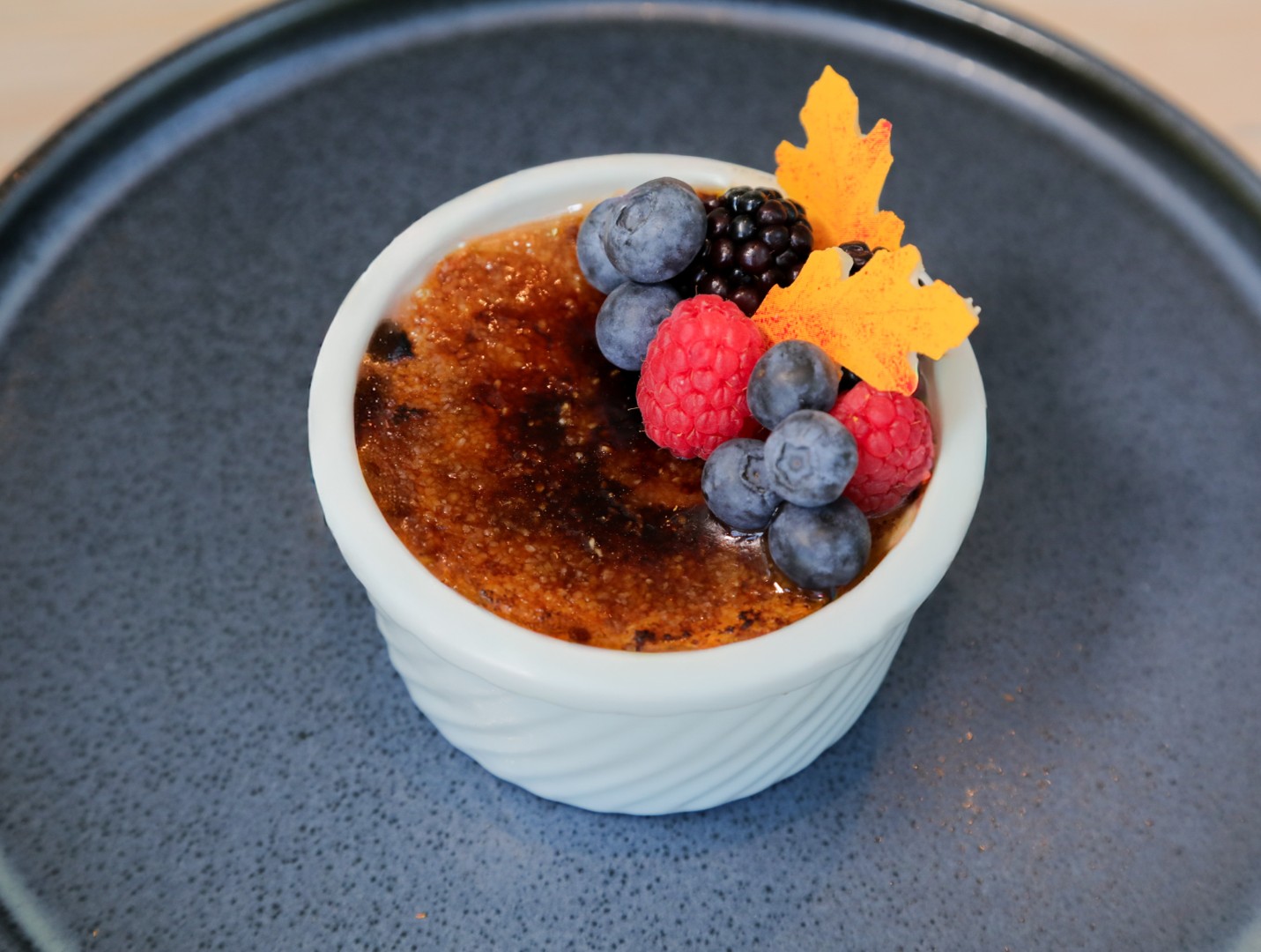Crème brûlée topped with fresh berries at Café in the Park