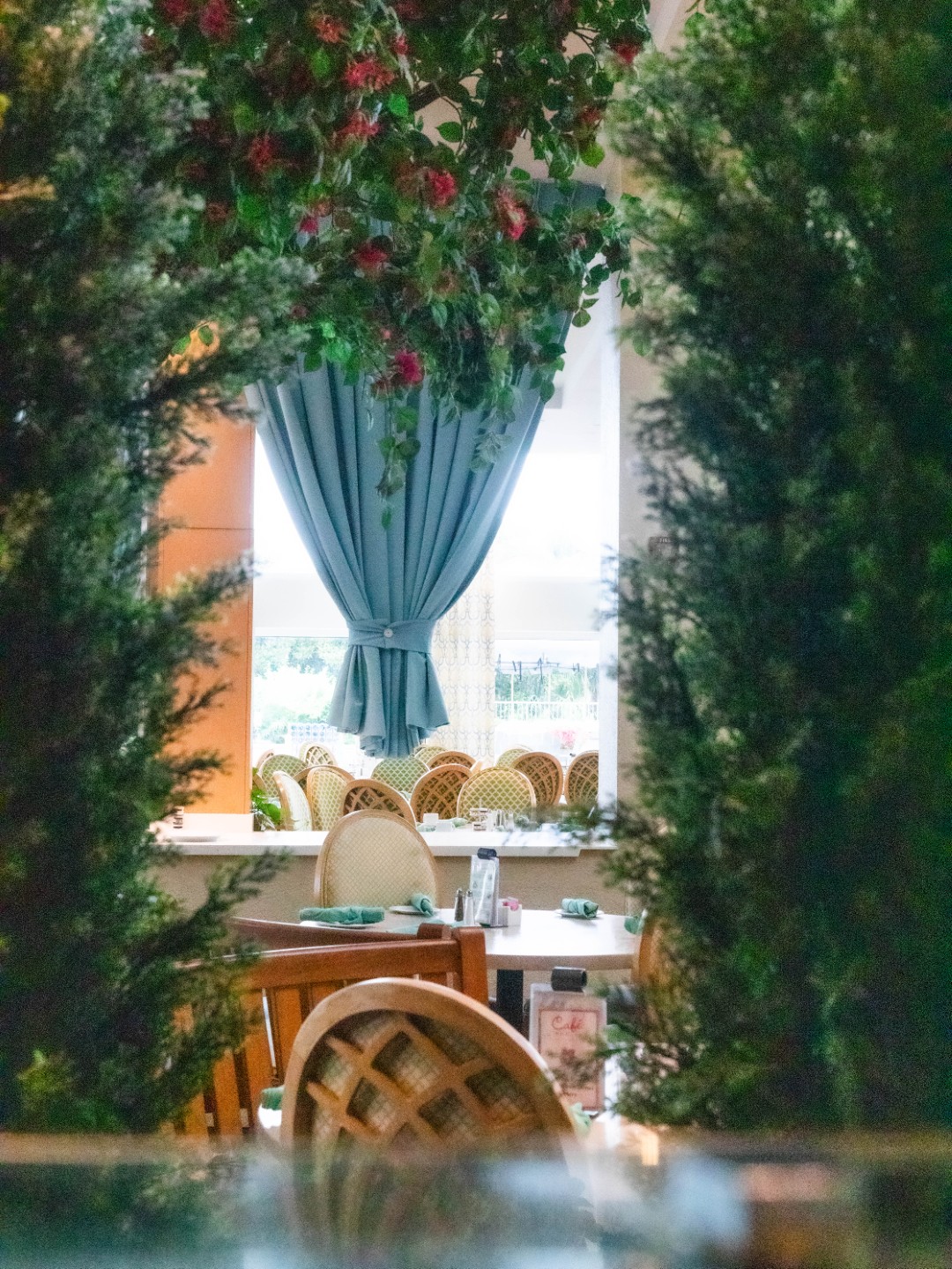 View through the greenery into Café in the Park