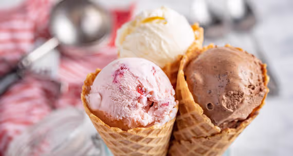 Three ice cream cones, each with a few scoops of pastel ice cream